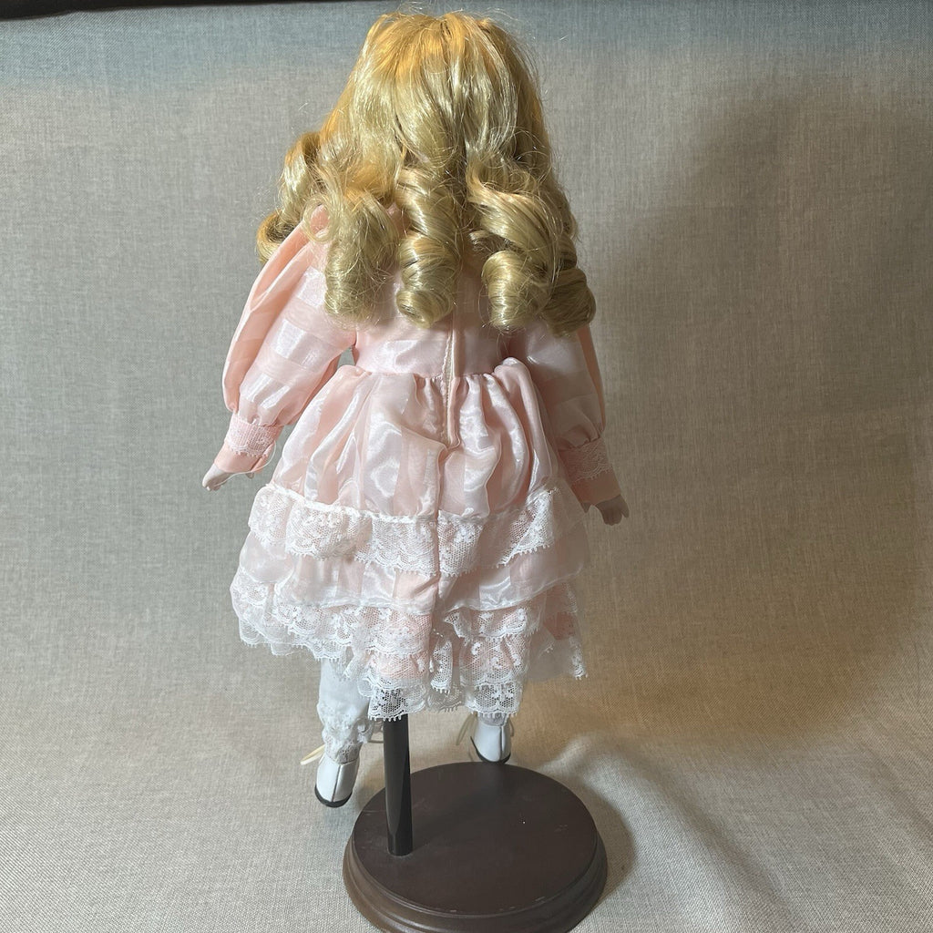 Dynasty doll collection. Porcelain Doll pink Ruffle dress.  17”