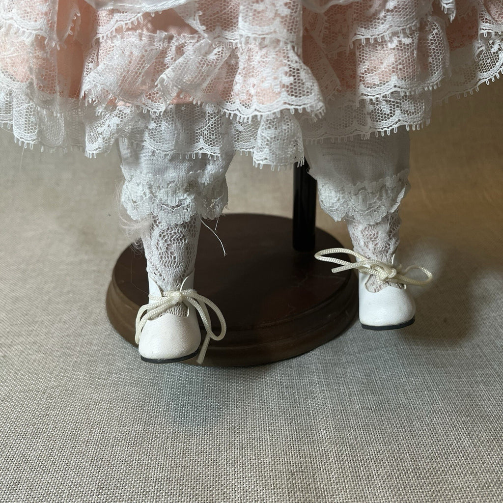 Dynasty doll collection. Porcelain Doll pink Ruffle dress.  17”