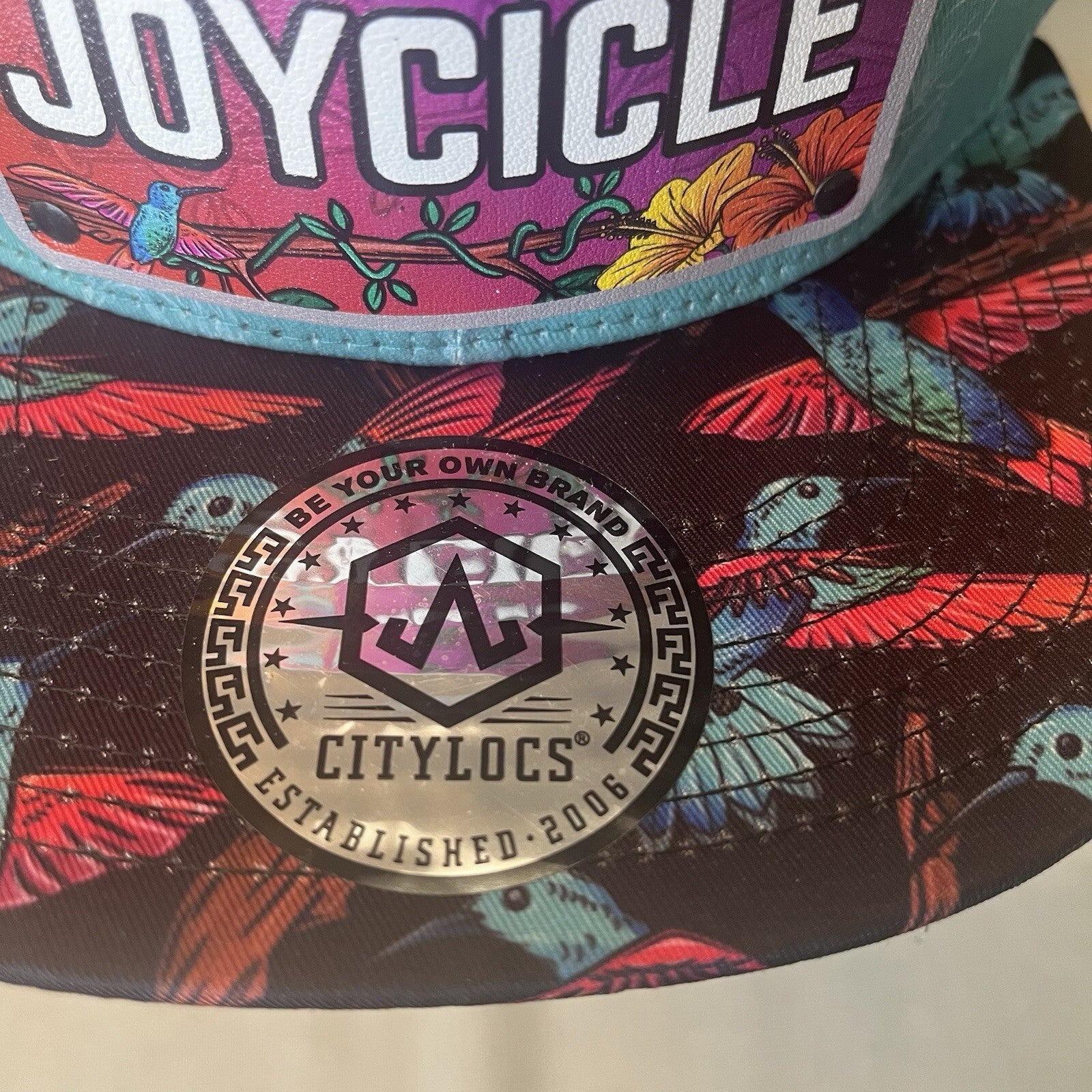 ADJUSTABLE SNAPBACK Hat Citylocs. Hummingbird print with front patch Joycicle