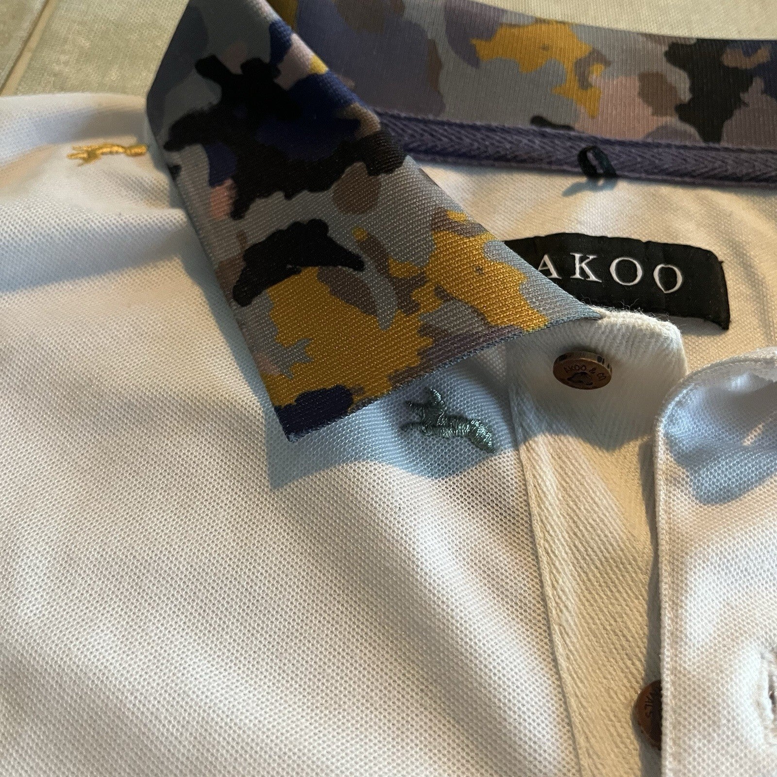 A cool polo shirt with camo collar an accent fox. White 3xl