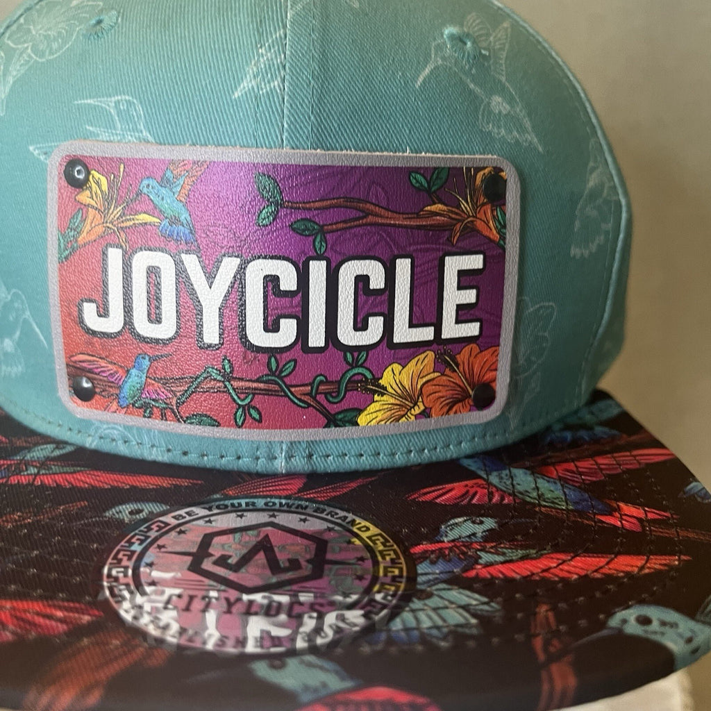 ADJUSTABLE SNAPBACK Hat Citylocs. Hummingbird print with front patch Joycicle