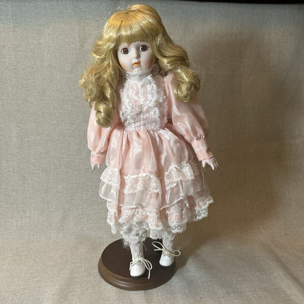 Dynasty doll collection. Porcelain Doll pink Ruffle dress.  17”