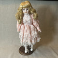 Dynasty doll collection. Porcelain Doll pink Ruffle dress.  17”
