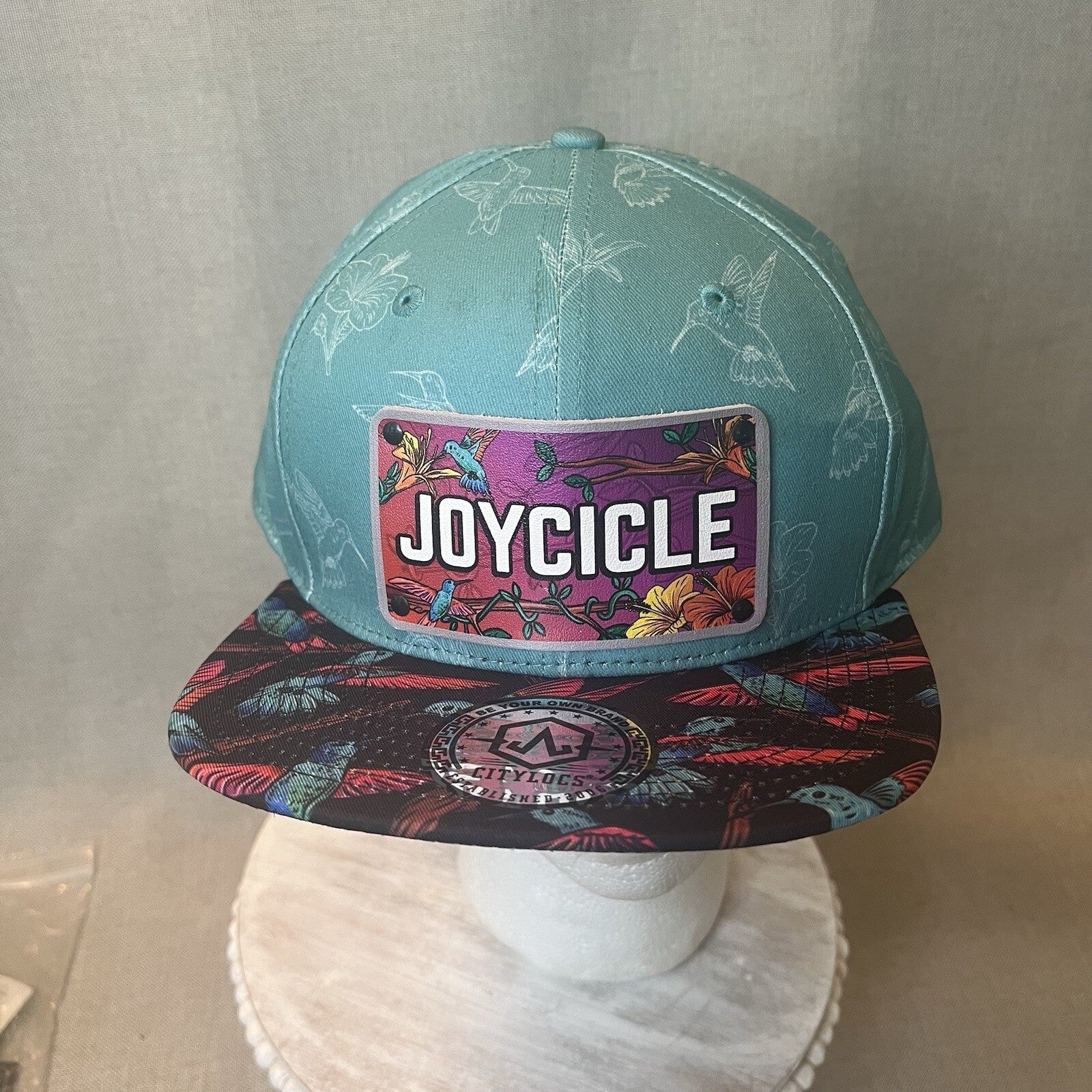 ADJUSTABLE SNAPBACK Hat Citylocs. Hummingbird print with front patch Joycicle