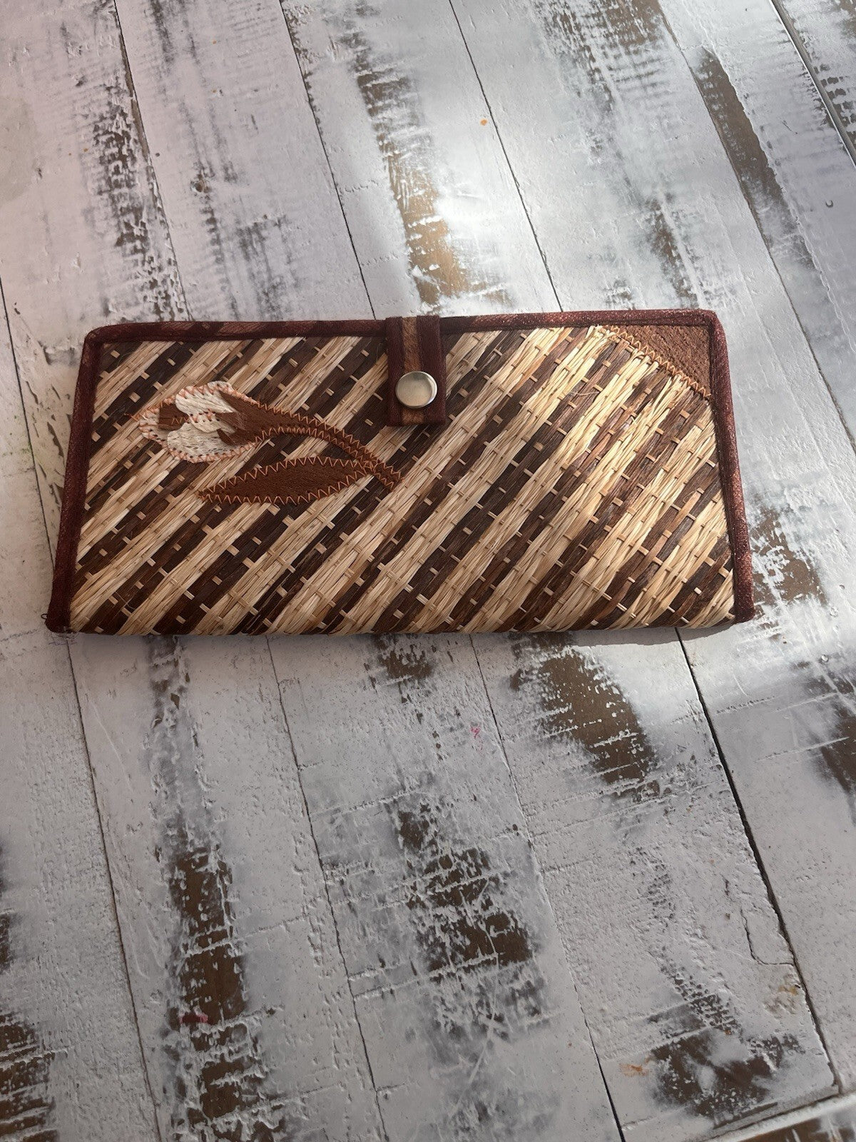 Bohemian style woven straw clutch, with snap closure and embroidered design