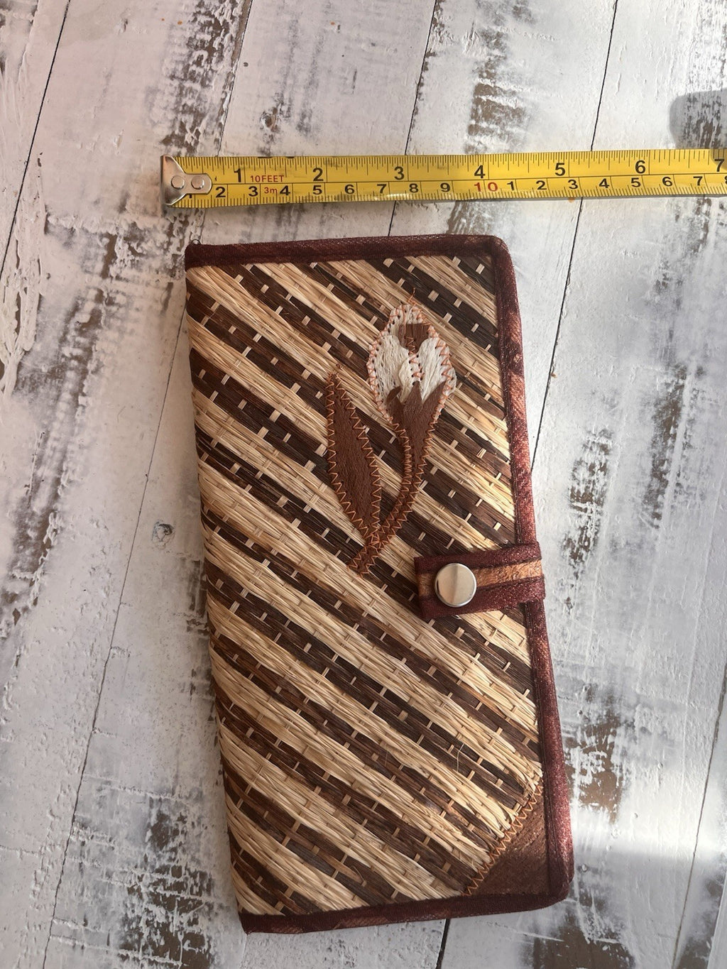 Bohemian style woven straw clutch, with snap closure and embroidered design