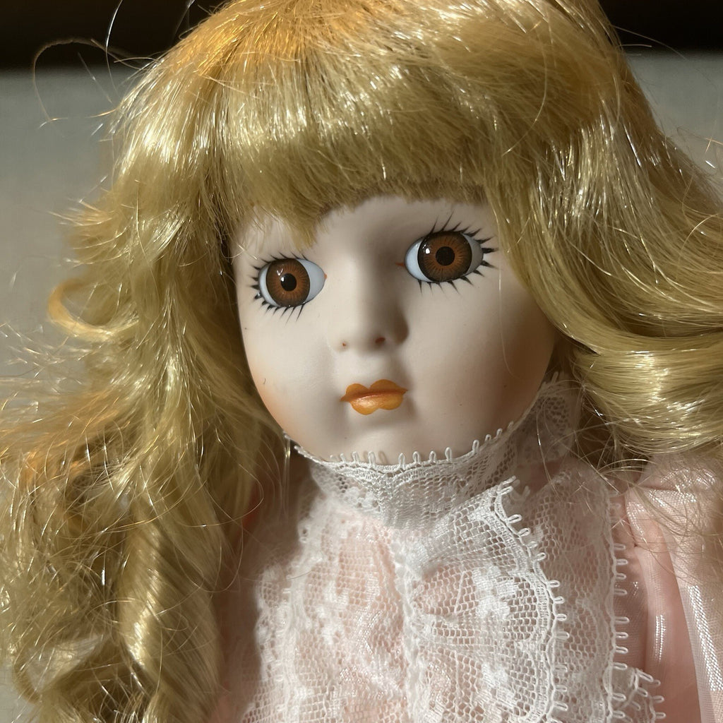 Dynasty doll collection. Porcelain Doll pink Ruffle dress.  17”